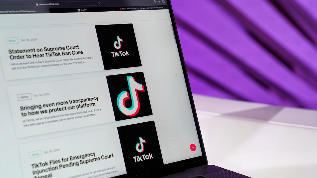 Crafting Captivating Headlines: Your awesome post title goes here Close-up of laptop screen showing TikTok news articles with a purple background.